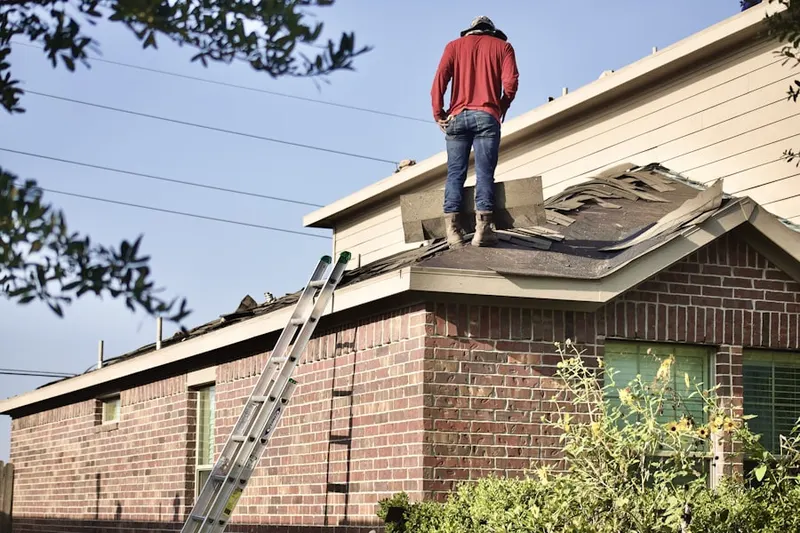 Professional roofer working on a residential roof in Winslow